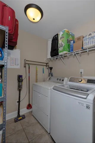 This dedicated laundry space combines convenience with practical storage solutions.
