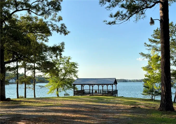 This serene lakeside gazebo offers picturesque water views and a perfect spot for outdoor enjoyment.