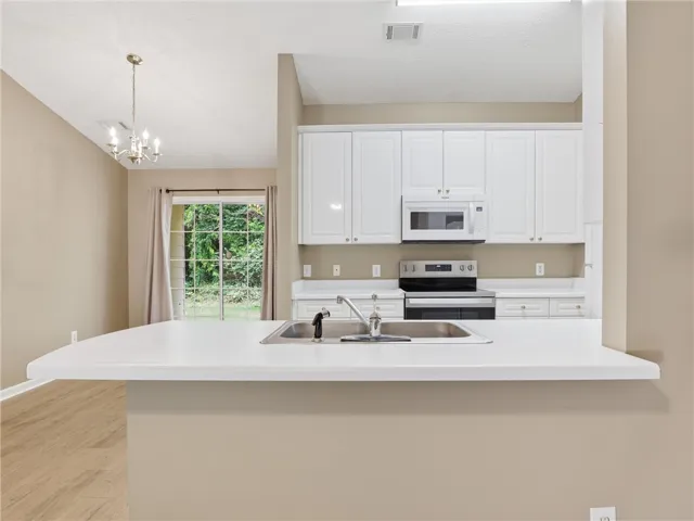 This spacious kitchen offers ample counter space and seamless flow for comfortable living.