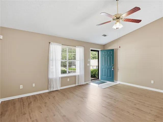 This inviting room features warm wood flooring and a refreshing open entryway.