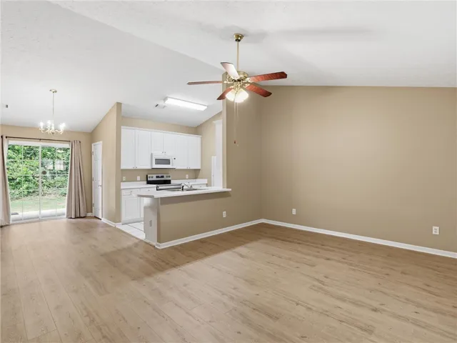 This bright and airy living space flows seamlessly into a modern kitchen, perfect for everyday living.