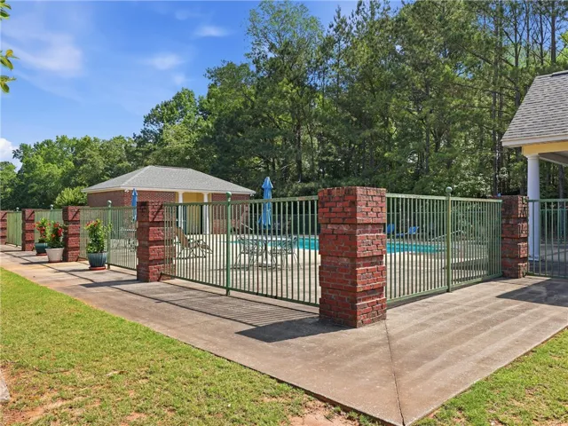 This neighborhood pool area, enclosed by a fence, offers a refreshing oasis for relaxation.