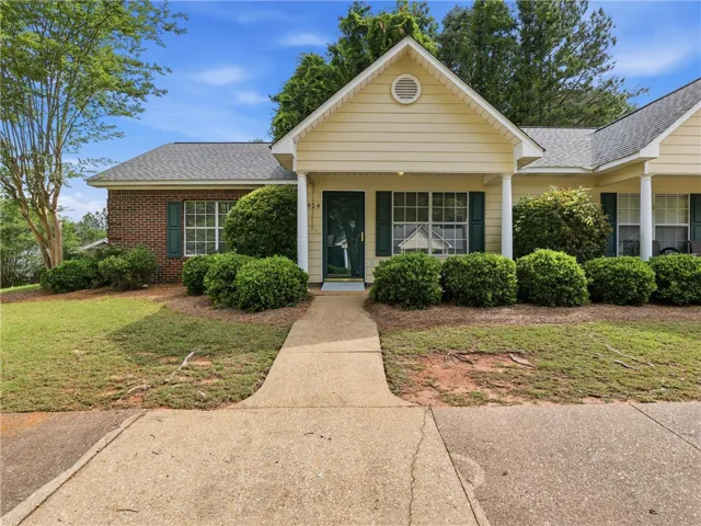 This charming home offers a welcoming facade with a classic porch and well-maintained landscaping.