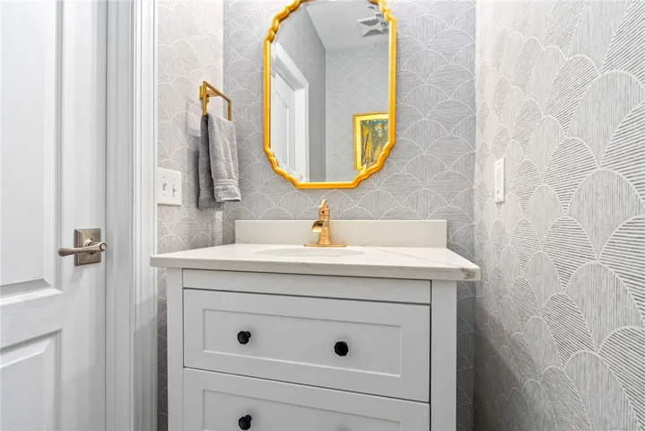 This sleek bathroom features elegant fixtures and a sophisticated vanity.
