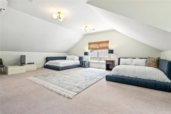 This spacious bedroom offers comfortable living with ample natural light.