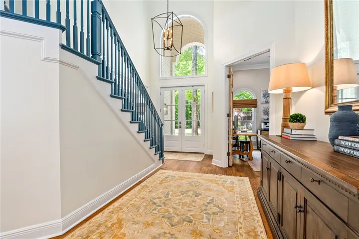 This grand foyer showcases elegant architectural details, welcoming all who enter with warmth and style.