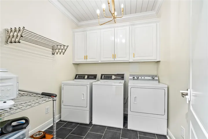 This laundry room features ample storage, practical appliances, and a convenient drying rack.