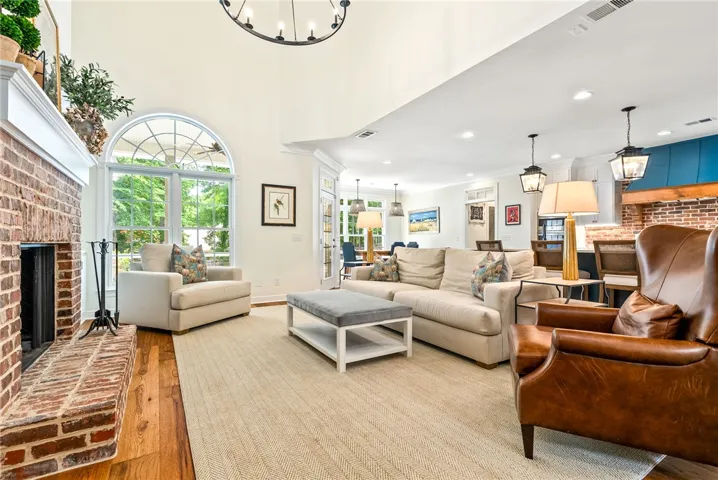 This airy living area features a grand fireplace and abundant natural light.