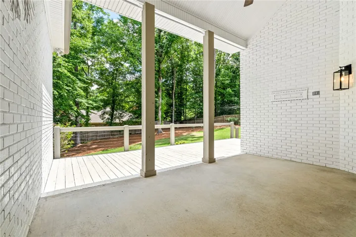Enjoy outdoor living on this expansive porch, perfect for relaxation and entertaining.