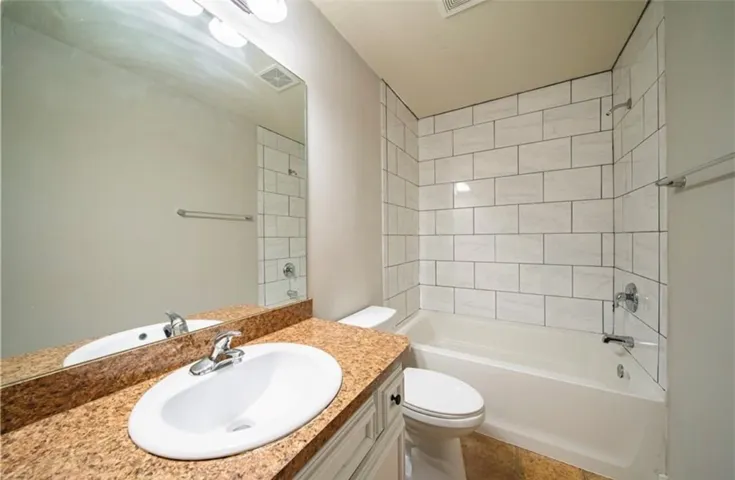 This bathroom features a sleek vanity, tiled shower, and convenient amenities for daily living.
