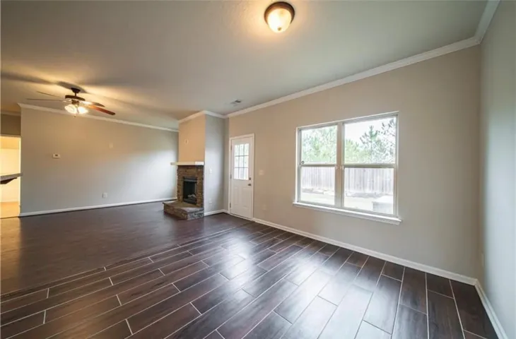 This living area features a charming fireplace and bright windows, creating a cozy and inviting atmosphere.