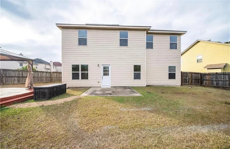 The rear exterior features a spacious yard, perfect for outdoor activities and relaxation.