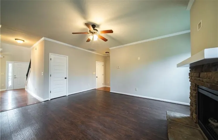 This inviting living space features rich hardwood flooring and a cozy fireplace.