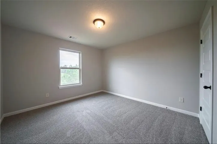 This spacious room offers comfort with carpet flooring and ample natural light.