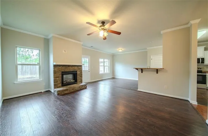 This inviting living space features warm flooring, a cozy fireplace, and abundant natural light.