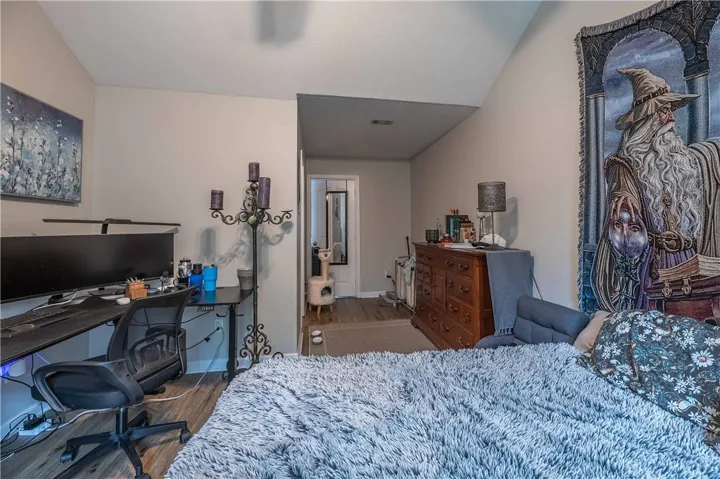 Hardwood-style flooring and varied ceiling heights define this comfortable and functional space.
