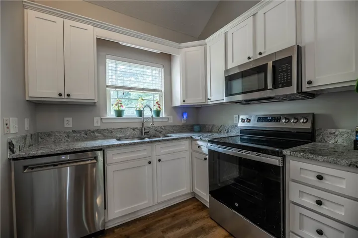 Culinary delights await in this bright kitchen, complete with ample cabinetry and modern appliances.