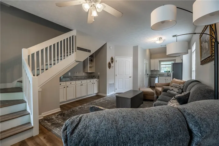 Discover a welcoming great room with wood-look flooring and a functional built-in bar, perfect for entertaining.