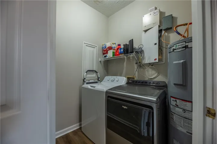 Functional utility room featuring modern appliances and a convenient storage shelf.
