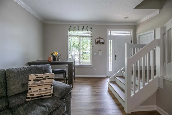 Hardwood-style flooring extends from the inviting entryway through the main living area.