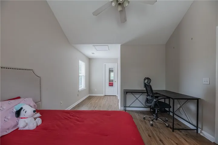 An airy bedroom with a stylish bed and contemporary workspace provides a comfortable living experience.