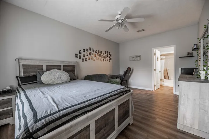 Wood flooring and a ceiling fan create a comfortable, well-ventilated personal space.