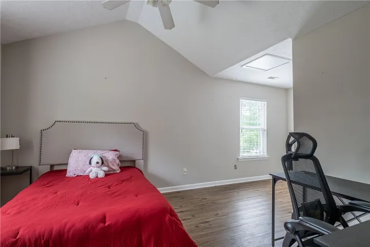 Slanted ceilings and modern flooring create a unique and comfortable personal retreat.