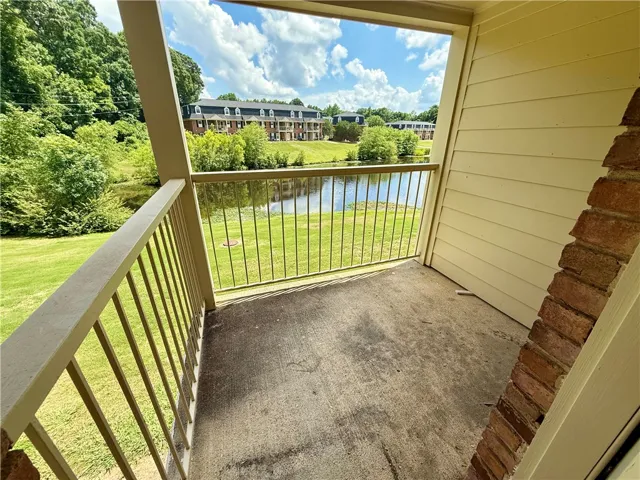 Enjoy tranquil water views and lush greenery from this inviting outdoor balcony.