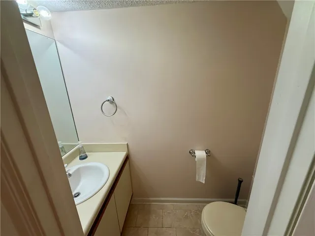 This powder room features a practical vanity and a neutral palette, offering everyday comfort.