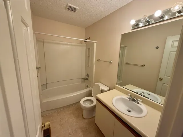 This bathroom offers a functional layout with essential fixtures for daily routines.