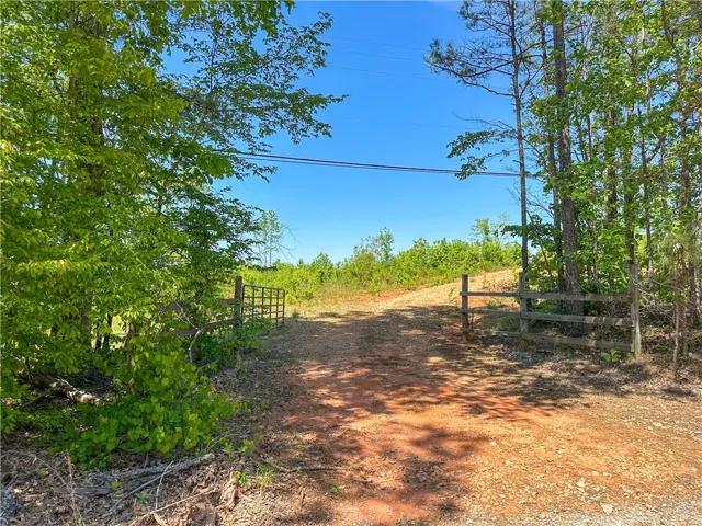 This scenic landscape features a private entrance to a serene natural setting.