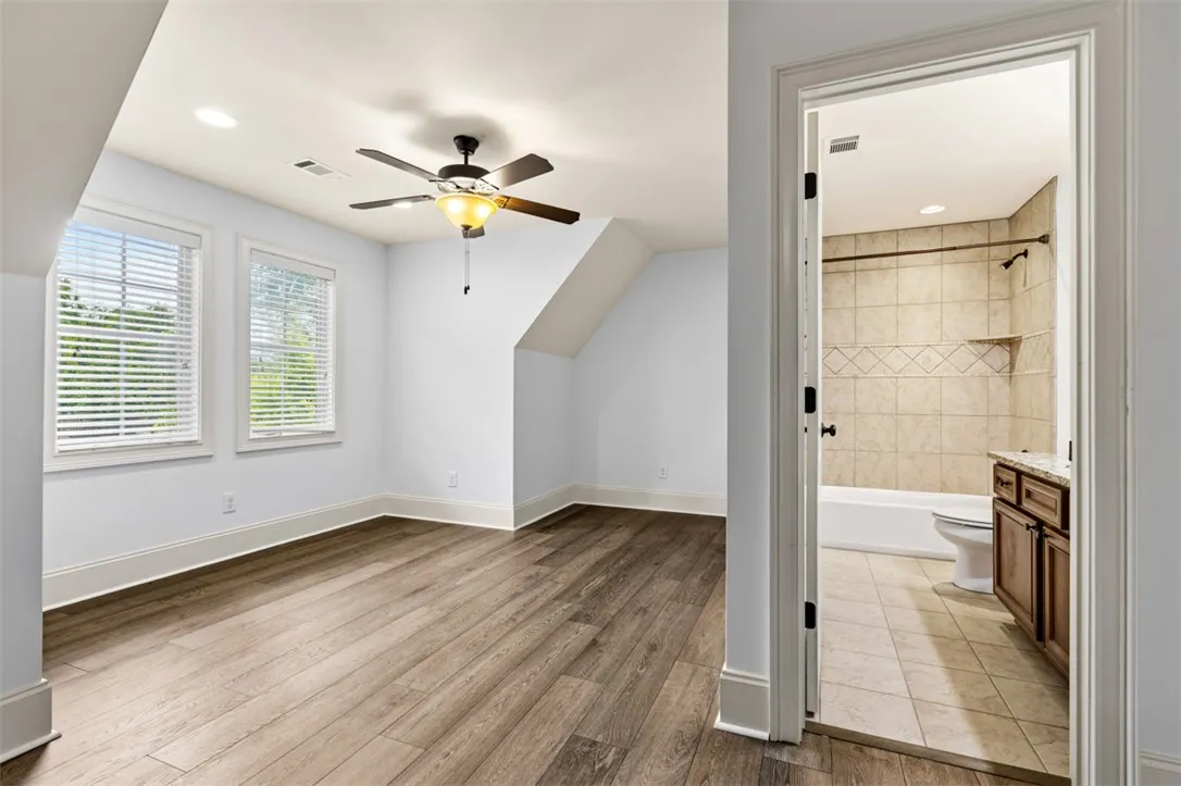 This spacious room features ample natural light and direct access to a well-appointed bathroom.