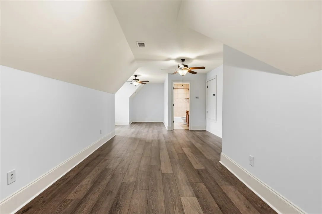 This spacious bonus room features sloping ceilings and beautiful flooring.