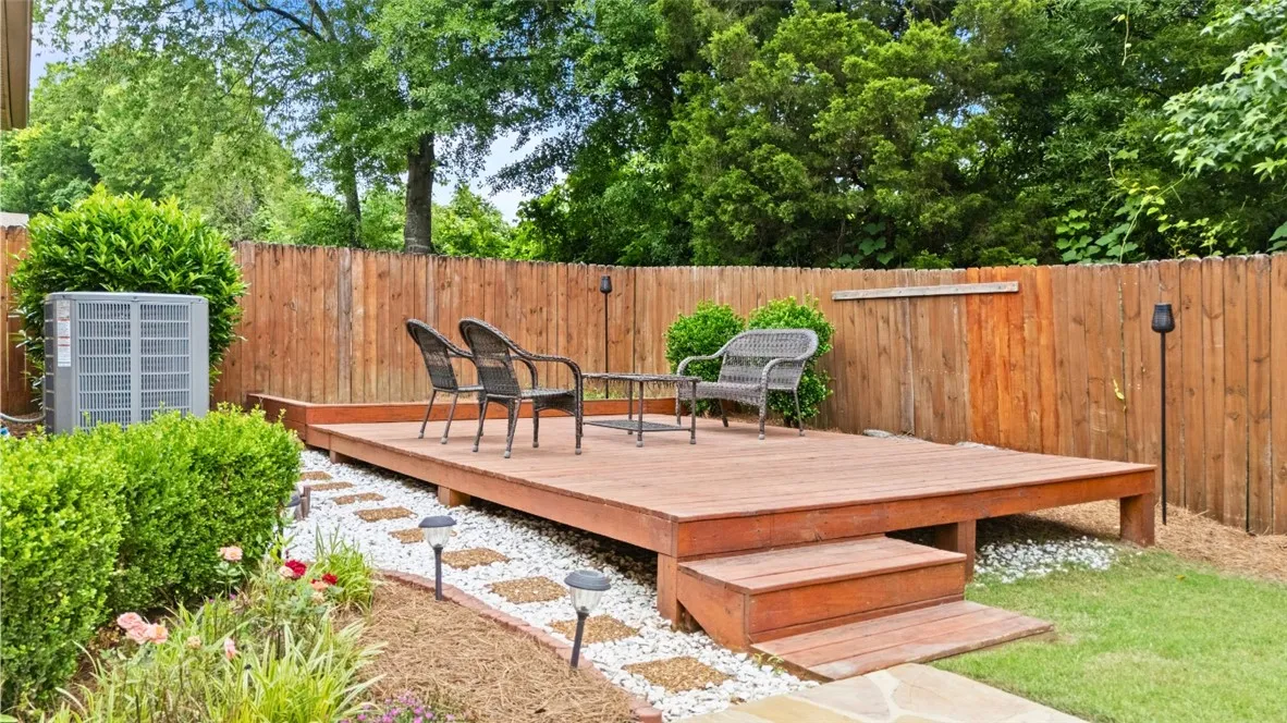 A private outdoor space features a wooden deck, perfect for relaxation and enjoying the greenery.