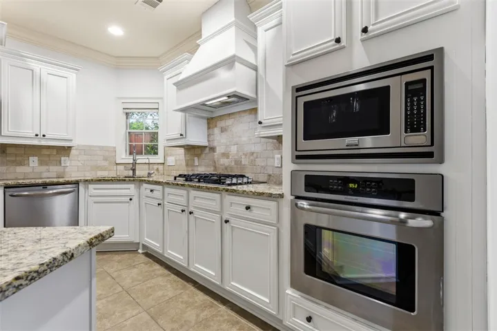 This bright kitchen features ample counter space, modern appliances, and elegant cabinetry.