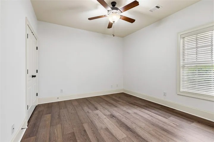This bright and airy room features elegant wood flooring and abundant natural light.
