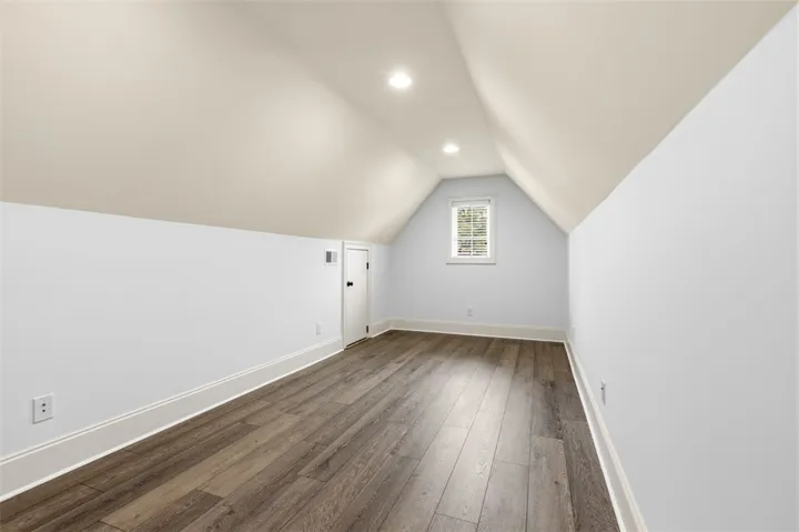 This spacious room features ample light and elegant flooring, perfect for versatile living.