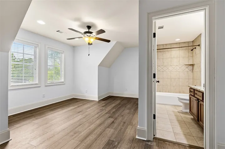 This spacious room features ample natural light and direct access to a well-appointed bathroom.