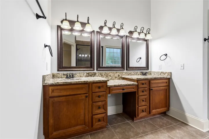 This spacious bathroom features a double vanity and sleek fixtures, perfect for daily routines.