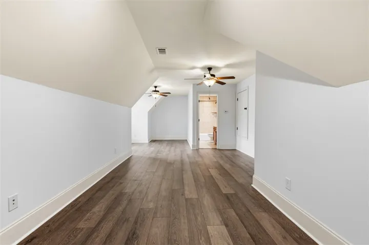 This spacious bonus room features sloping ceilings and beautiful flooring.