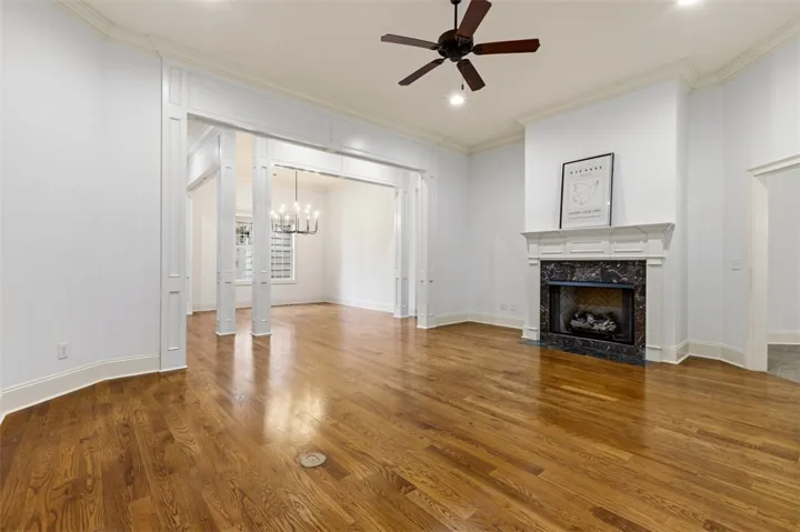 This expansive living area features lustrous hardwood floors and an elegant fireplace.