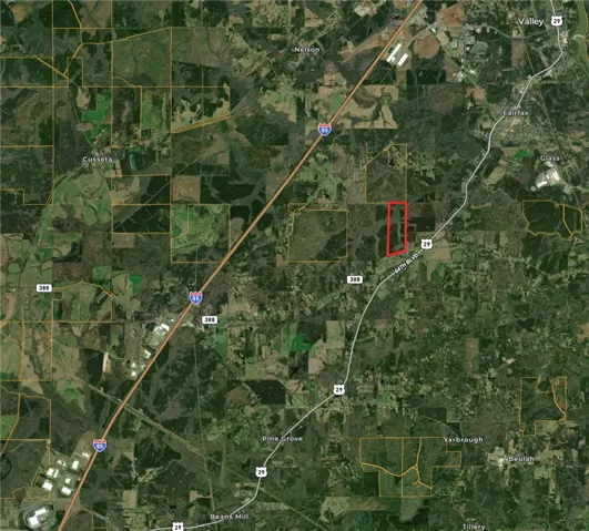 This aerial view showcases a lot with convenient road access, perfect for diverse development opportunities.