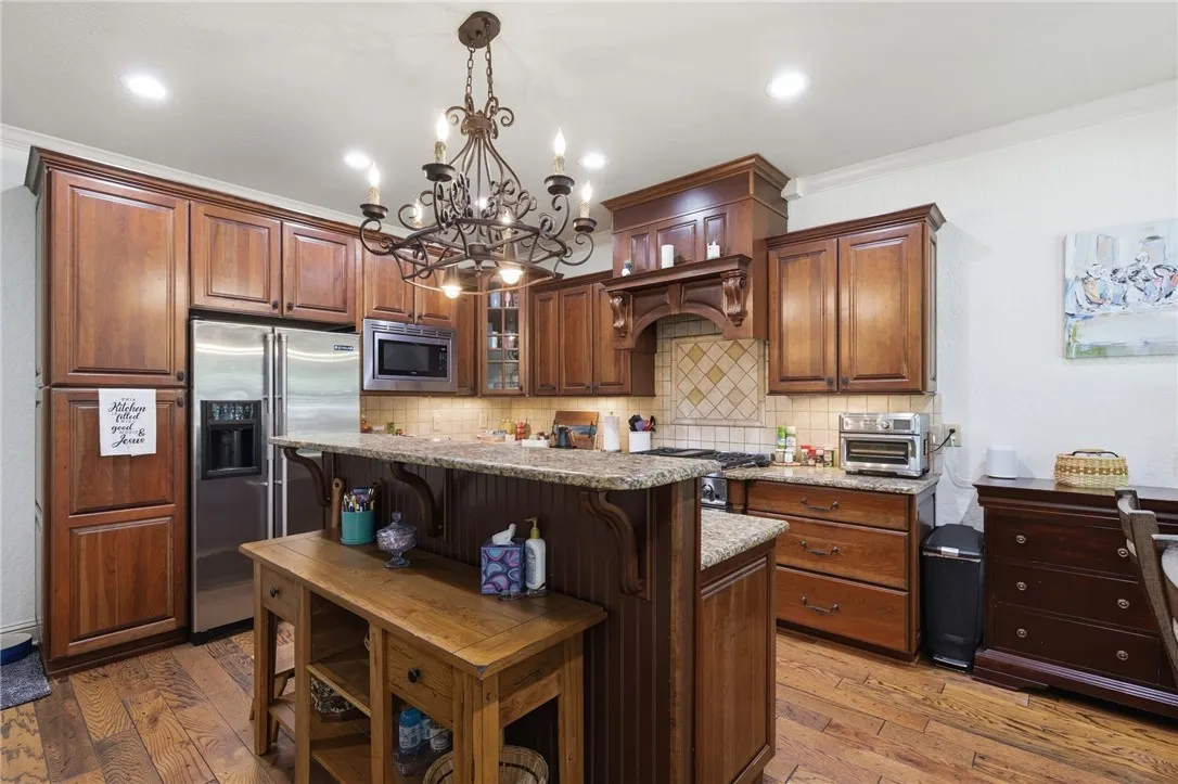 An inviting kitchen with rich wood cabinetry and ample counter space for culinary creativity.