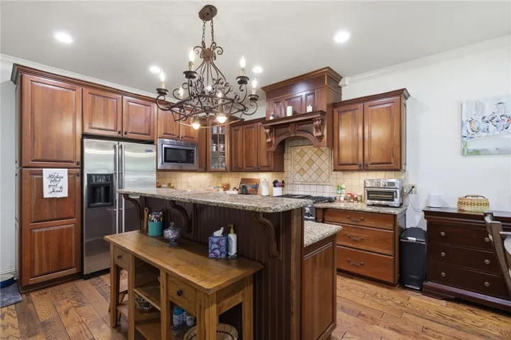 An inviting kitchen with rich wood cabinetry and ample counter space for culinary creativity.