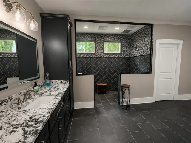Luxurious bathroom with ample counter space and a spacious zero entry shower.