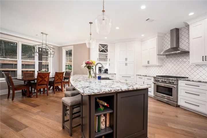 Gleaming wood floors and contemporary fixtures define this elegant kitchen, perfect for culinary adventures and entertaining.