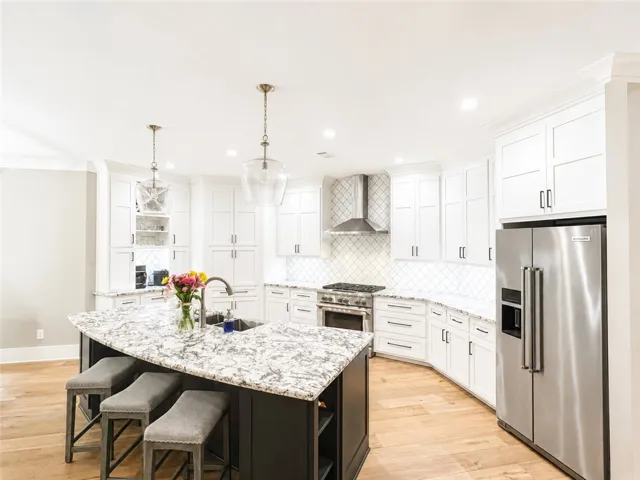 Culinary creations come to life in this spacious kitchen, featuring a central island with seating.