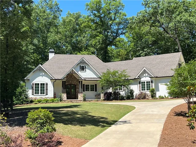 This charming home offers a perfect blend of comfort and style with its beautiful architecture and lush landscaping.