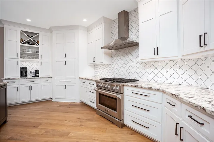 Culinary delights await in this bright Chef's kitchen with KitchenAid professional grade 6 burner gas stove and convection oven.