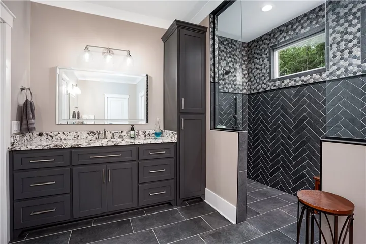 A well-appointed bath features 2 spacious vanities and zero entry shower